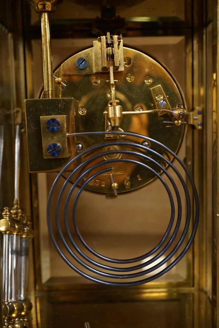 A four glass and brass mantel clock, 25cm high, 17cm wide.